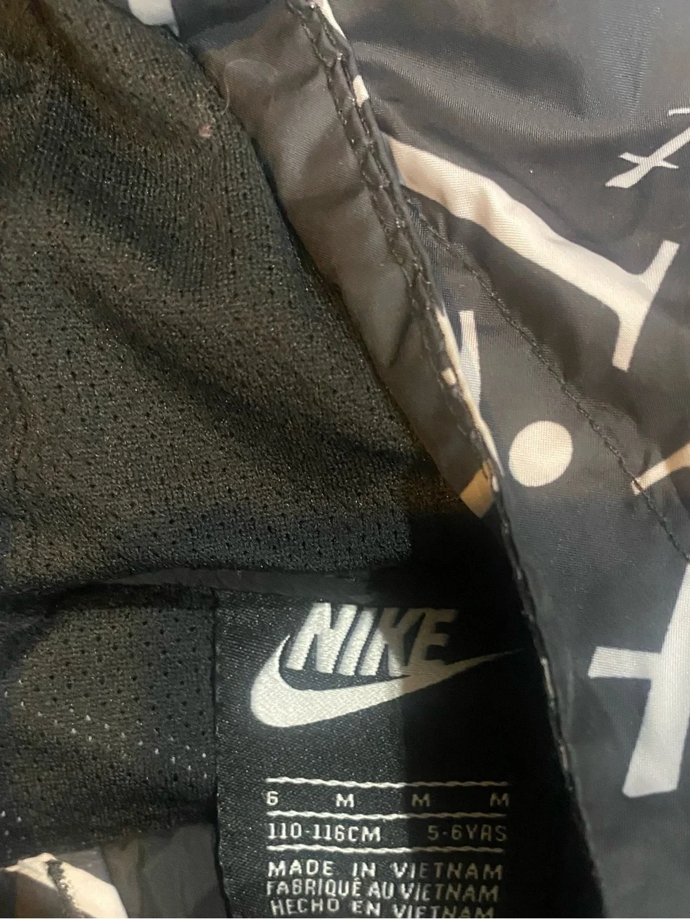 Nike Kids Black Hooded Rain Jacket with White Script